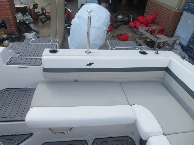 Slide: The Image of 2023 Starcraft SVX OB 191 OB boat interior with cushioned seating and cup holders. - 16