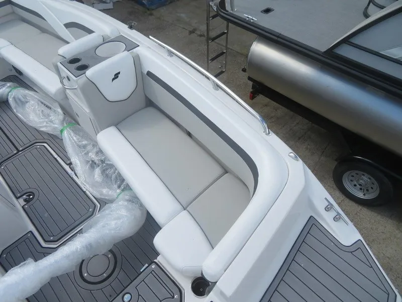 Slide: The Image of 2023 Starcraft SVX OB 191 OB boat interior with cushioned seating and storage compartments. - 4