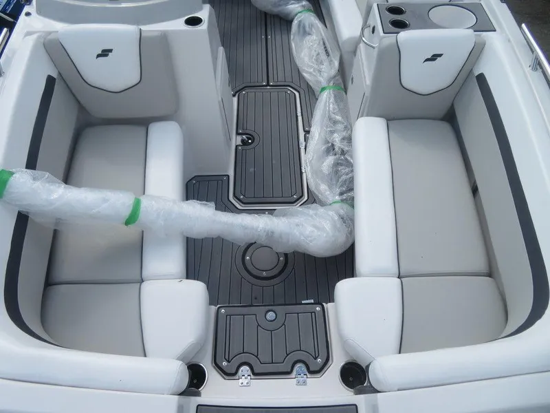 Slide: The Image of 2023 Starcraft SVX OB 191 OB boat interior with white seating and black flooring. - 6