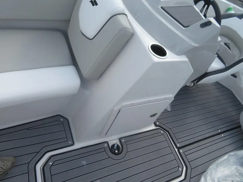 Slide: The Image of 2023 Starcraft SVX OB 191 OB boat interior with gray flooring and white seating. - 8
