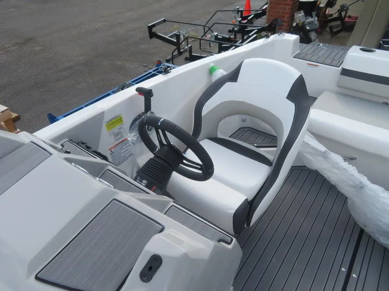 Slide: The Image of 2023 Starcraft SVX OB 191 OB boat interior with steering wheel and captain's chair. - 9