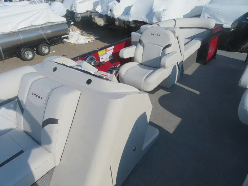 Slide: The Image of 2023 Crest Classic LX 240 SLC CPT pontoon boat interior with plush seating. - 11