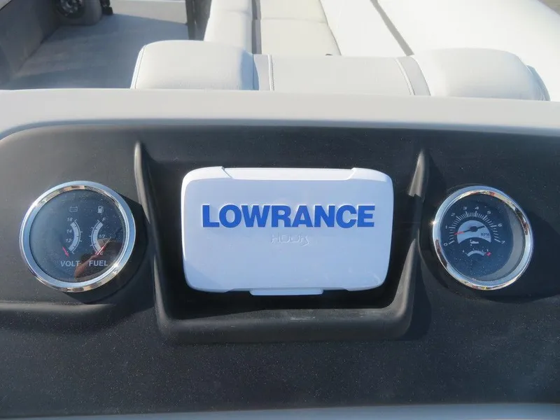 Slide: The Image of 2023 Crest Classic LX 240 SLC CPT dashboard with Lowrance display and gauges. - 4