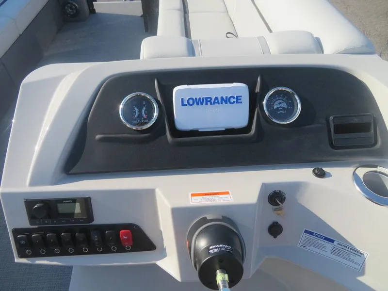 Slide: The Image of 2023 Crest Classic LX 240 SLC CPT boat dashboard with Lowrance display and control panel. - 7