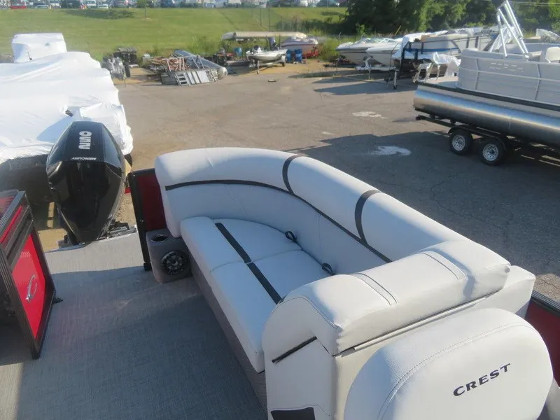 Slide: The Image of 2023 Crest Classic LX 240 SLC CPT pontoon boat with spacious seating and outboard motor. - 8