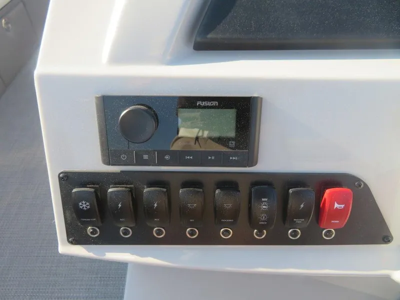 Slide: The Image of Control panel of 2023 Crest Classic LX 240 SLC CPT boat with Fusion stereo system. - 9