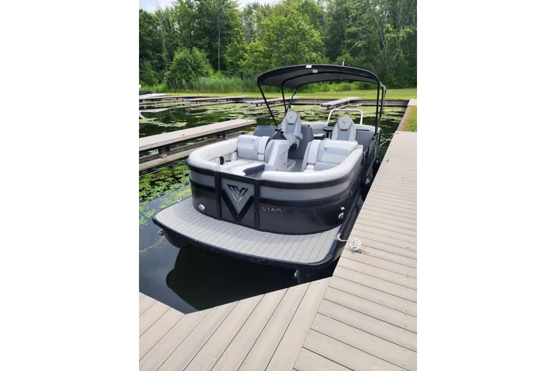 The Image of 2023 Viaggio Diamante 23U pontoon boat docked on a serene lake. - 0