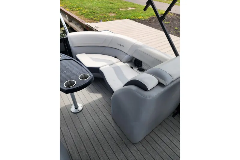 Slide: The Image of Luxurious seating on 2023 Viaggio Diamante 23U pontoon boat with cup holders and table. - 34