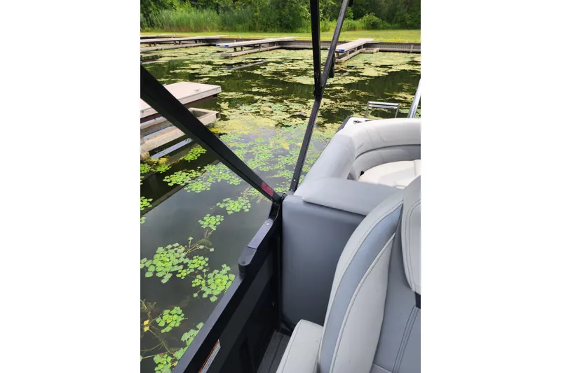 Slide: The Image of 2023 Viaggio Diamante 23U boat interior near dock with water plants. - 44