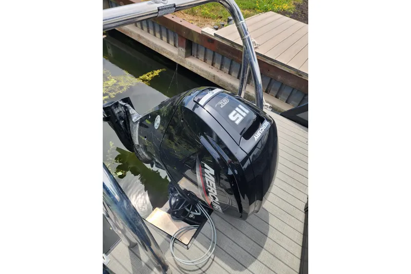 Slide: The Image of Outboard motor on 2023 Viaggio Diamante 23U boat docked by wooden pier. - 47