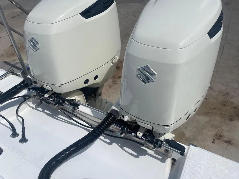 Slide: The Image of Twin outboard motors on a 2004 Venture 34 Open boat. - 10