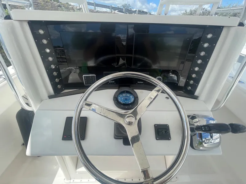 Slide: The Image of Steering console of a 2004 Venture 34 Open boat with modern controls and displays. - 4