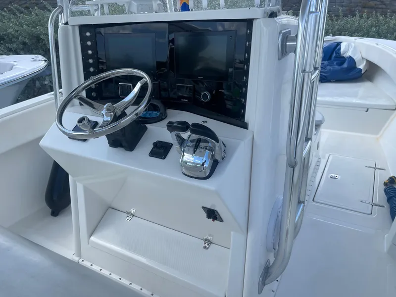 Slide: The Image of 2004 Venture 34 Open boat console with steering wheel and navigation screens. - 9