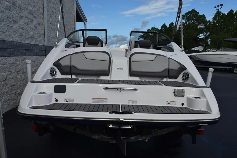 Slide: The Image of 2017 Yamaha Boats 212 Limited, rear view, docked, with dual seating and swim platform. - 4