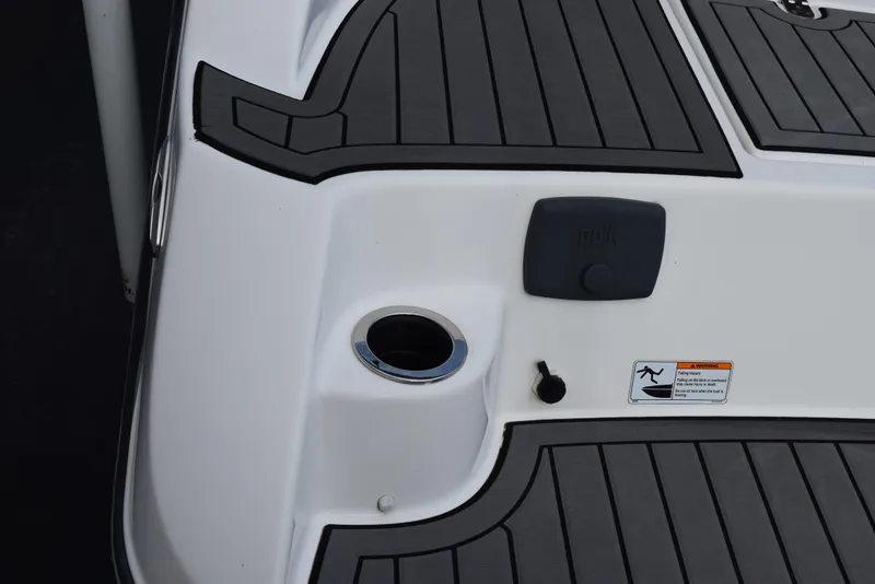 Slide: The Image of Close-up of 2017 Yamaha Boats 212 Limited deck with cup holder and warning label. - 5