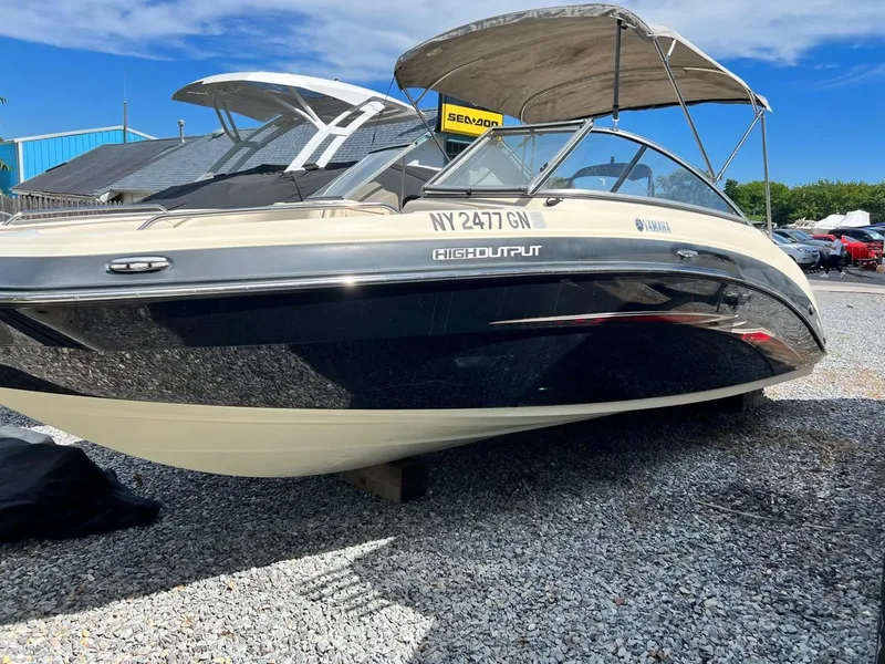 The Image of 2014 Yamaha Boats 242 Limited, high output, docked on gravel lot. - 0