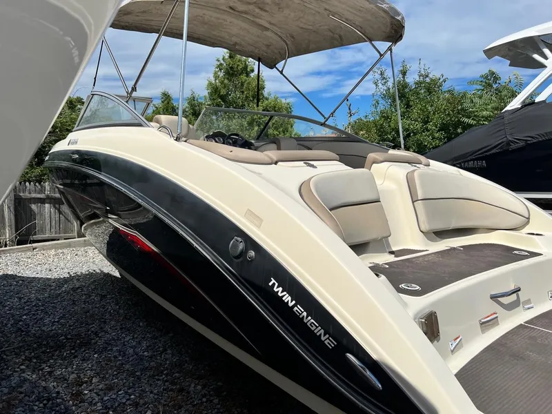 Slide: The Image of 2014 Yamaha Boats 242 Limited with twin engines, docked outdoors. - 1