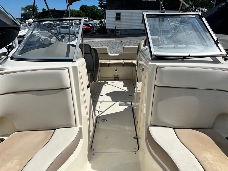 Slide: The Image of 2014 Yamaha Boats 242 Limited interior view with open windshield and seating. - 3