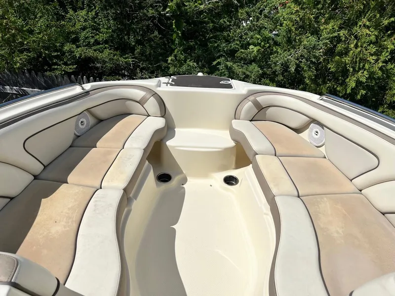 Slide: The Image of 2014 Yamaha Boats 242 Limited bow seating area with beige cushions and cup holders. - 4