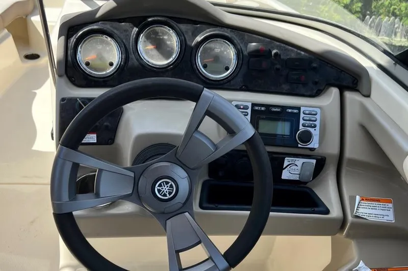 Slide: The Image of 2014 Yamaha Boats 242 Limited dashboard with steering wheel and instrument panel. - 8