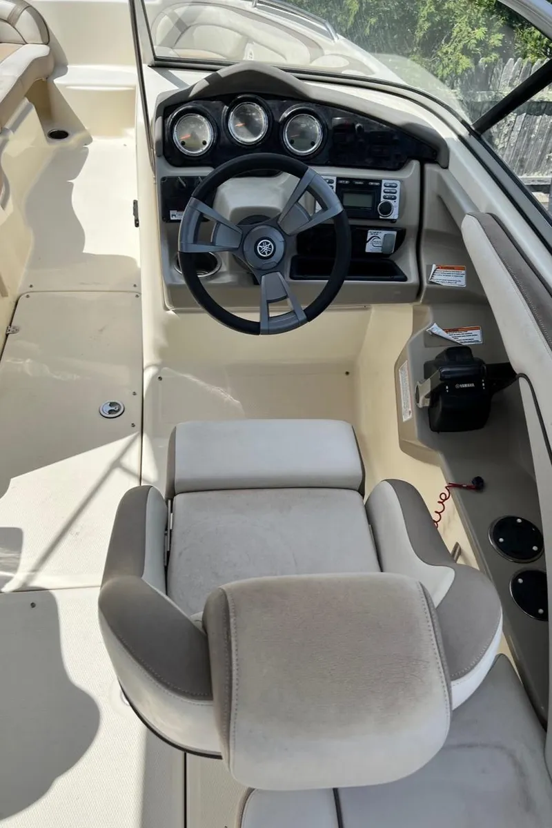 Slide: The Image of 2014 Yamaha Boats 242 Limited cockpit with steering wheel and control panel. - 9