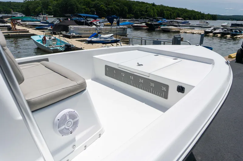 Slide: The Image of 2023 Savannah 190 IS boat docked at a marina with various other boats. - 10