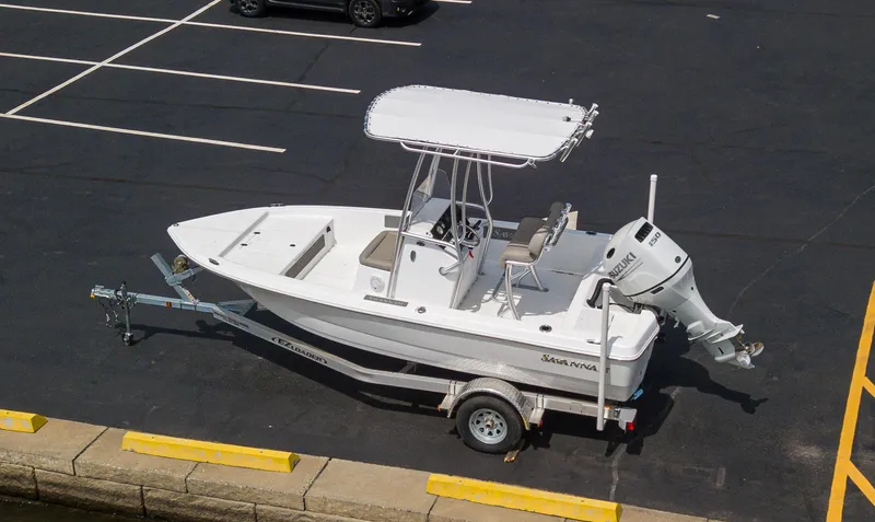 Slide: The Image of 2023 Savannah 190 IS boat on trailer in parking lot. - 2