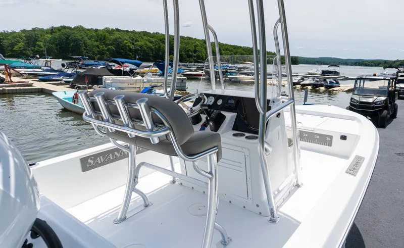 Slide: The Image of 2023 Savannah 190 IS boat at marina with multiple boats in background. - 5