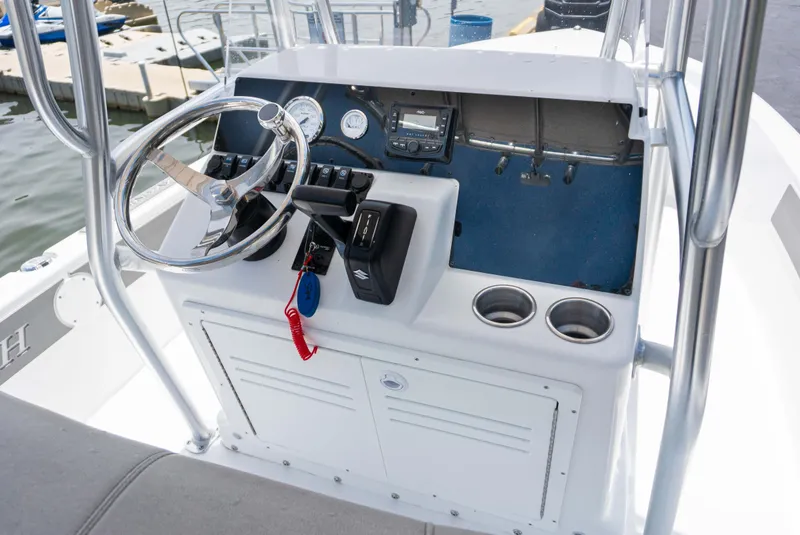 Slide: The Image of Control console of a 2023 Savannah 190 IS boat with steering wheel and gauges. - 7
