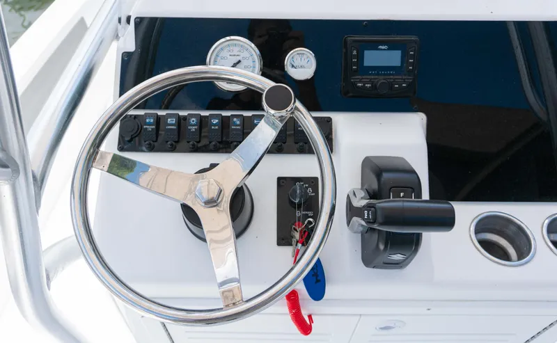 Slide: The Image of Control panel of a 2023 Savannah 190 IS boat with steering wheel and gauges. - 8