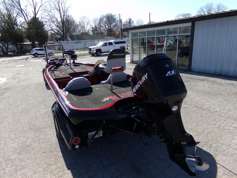Slide: The Image of 2000 Ranger 518SVX Comanche boat with Mercury engine, parked outdoors. - 10