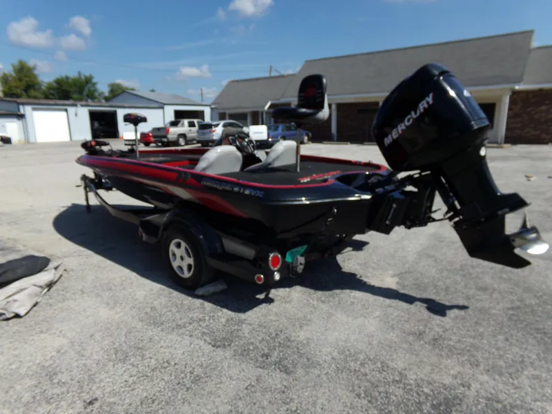 Slide: The Image of 2000 Ranger 518SVX Comanche boat with Mercury engine in a parking lot. - 13