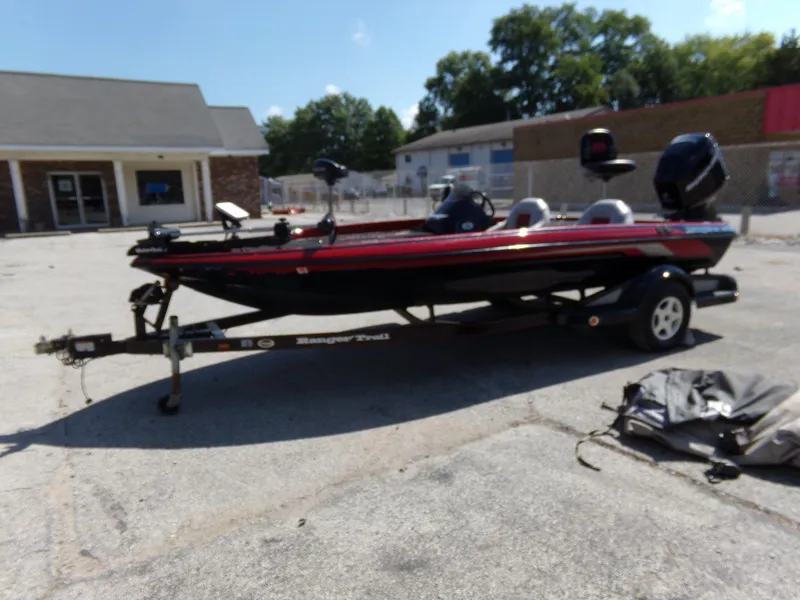 Slide: The Image of 2000 Ranger 518SVX Comanche boat on trailer in parking lot. - 14