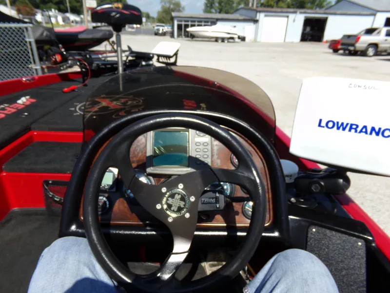 Slide: The Image of Cockpit view of a 2000 Ranger 518SVX Comanche boat with steering wheel and Lowrance equipment. - 15
