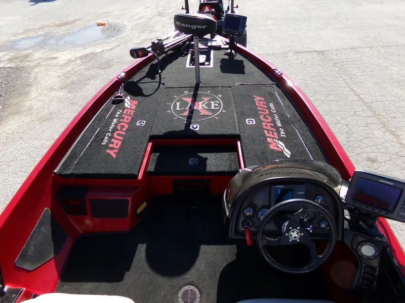 Slide: The Image of 2000 Ranger 518SVX Comanche boat interior with Mercury branding and steering console. - 2
