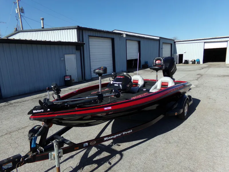 Slide: The Image of 2000 Ranger 518SVX Comanche boat on trailer in industrial area. - 3