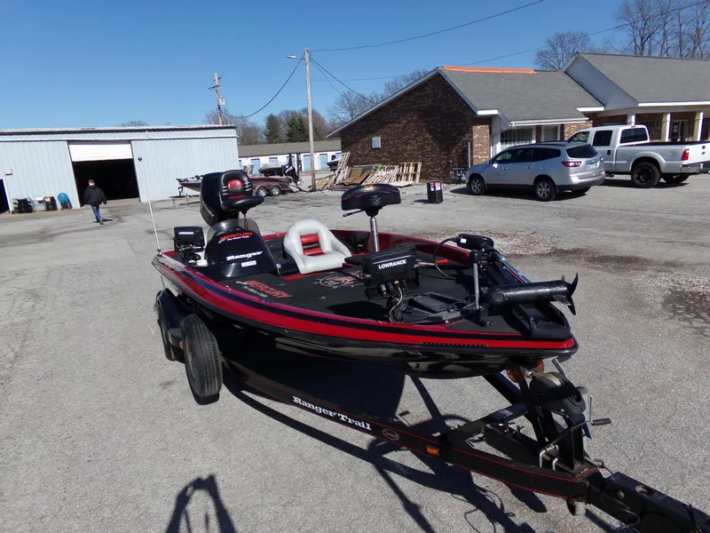 Slide: The Image of 2000 Ranger 518SVX Comanche boat on trailer in parking lot. - 4