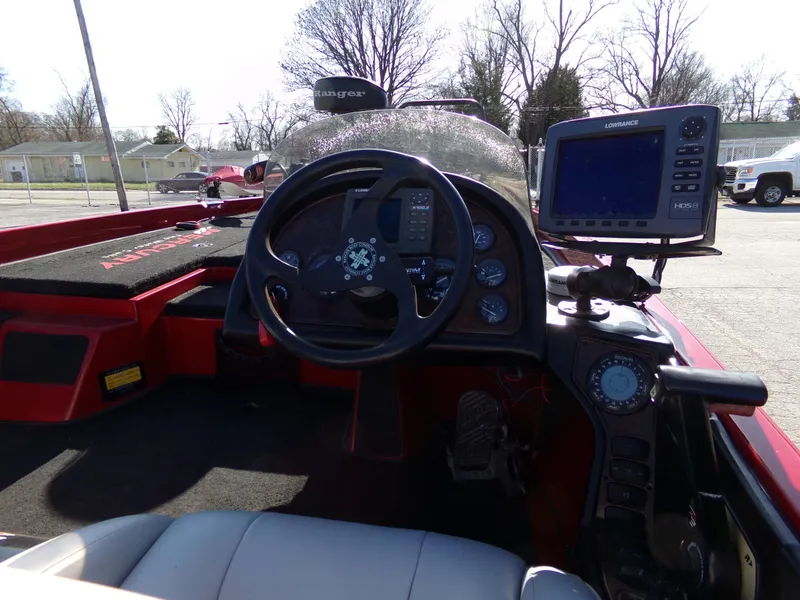 Slide: The Image of 2000 Ranger 518SVX Comanche boat cockpit with steering wheel and navigation system. - 5