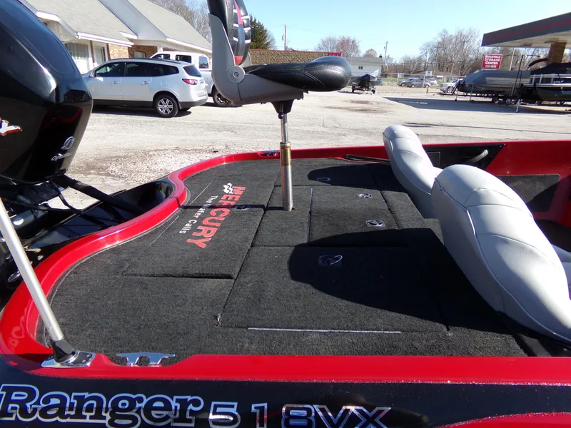 Slide: The Image of 2000 Ranger 518SVX Comanche boat with seating and Mercury branding, parked outdoors. - 6