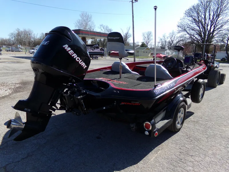 Slide: The Image of 2000 Ranger 518SVX Comanche boat with Mercury outboard motor, parked on a trailer. - 7
