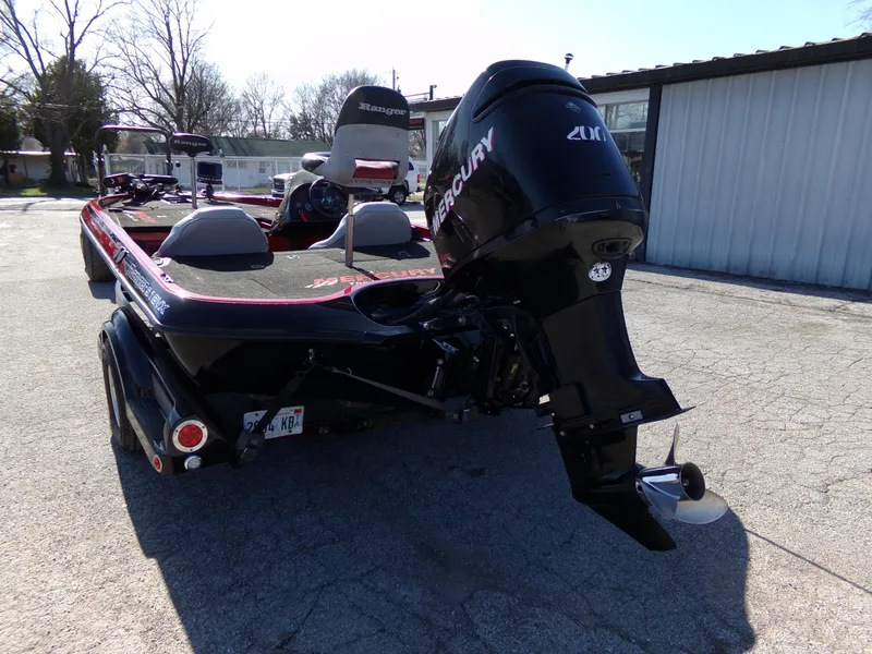 Slide: The Image of 2000 Ranger 518SVX Comanche boat with Mercury outboard motor, parked outdoors. - 9