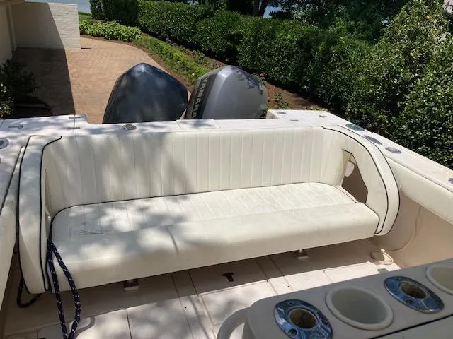 Slide: The Image of 2002 Intrepid 322 boat with white seating and twin outboard motors. - 10