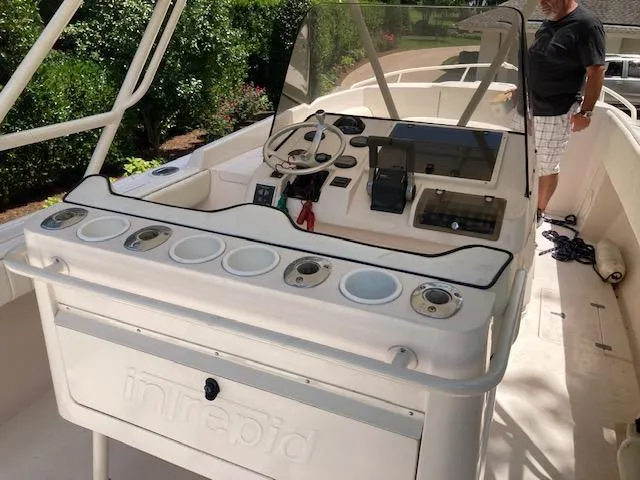 Slide: The Image of 2002 Intrepid 322 boat cockpit with steering wheel and control panel. - 11