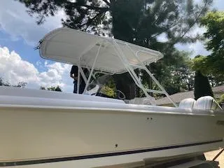 Slide: The Image of 2002 Intrepid 322 boat with T-top canopy in a sunny outdoor setting. - 14