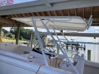 Slide: The Image of 2002 Intrepid 322 boat docked under a wooden shelter. - 15