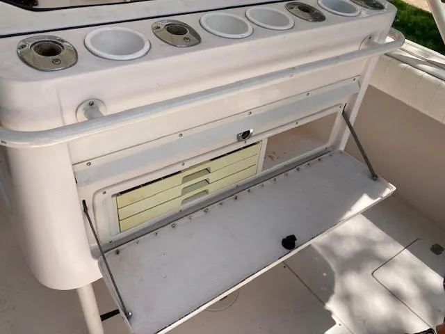 Slide: The Image of 2002 Intrepid 322 boat fishing station with rod holders and storage compartments. - 6