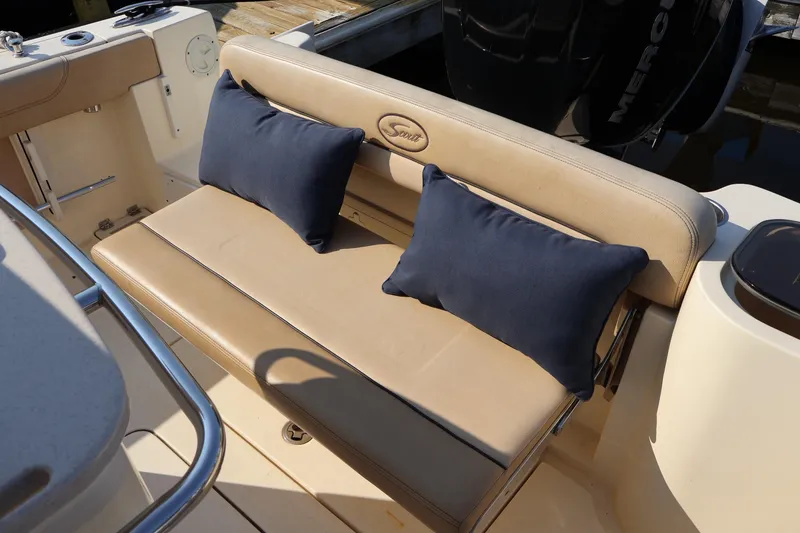 Slide: The Image of 2016 Scout 255 LXF boat seating with beige cushions and navy pillows. - 15