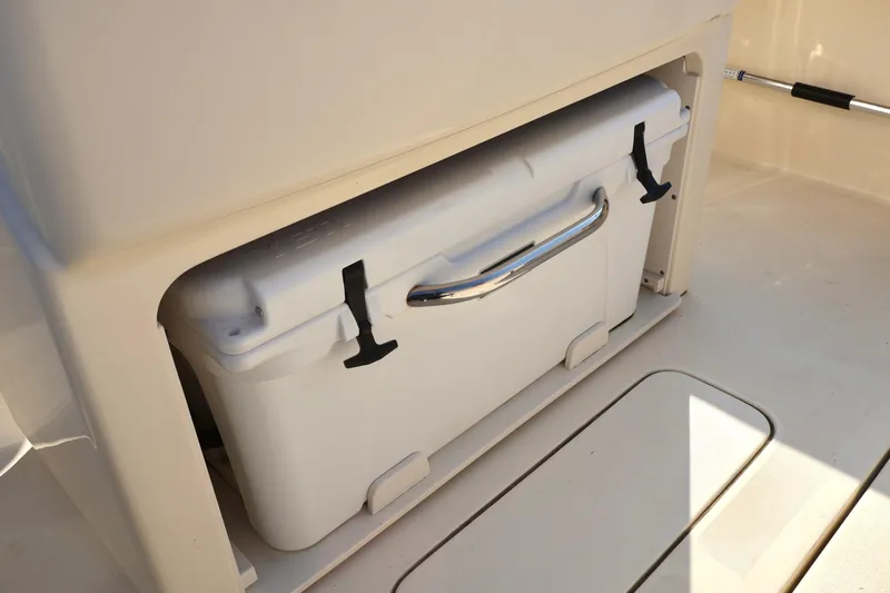 Slide: The Image of 2016 Scout 255 LXF boat cooler storage compartment. - 16