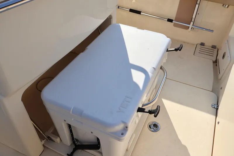 Slide: The Image of 2016 Scout 255 LXF boat interior with white cooler. - 17