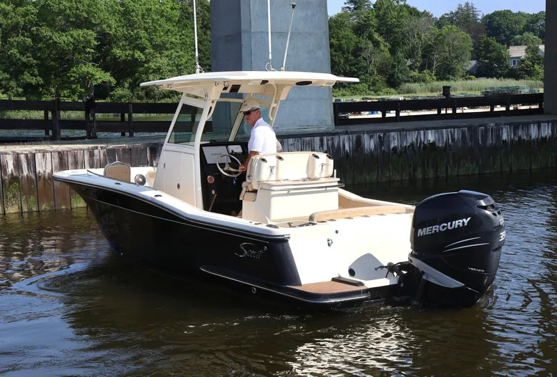 Slide: The Image of 2016 Scout 255 LXF boat with Mercury engine on calm water. - 2